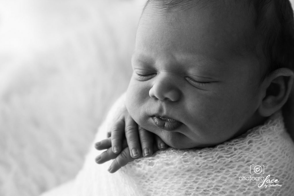 lHow soothe newborn baby. Lttle baby boy peacefully sleeping wrapped in a soft white swaddle