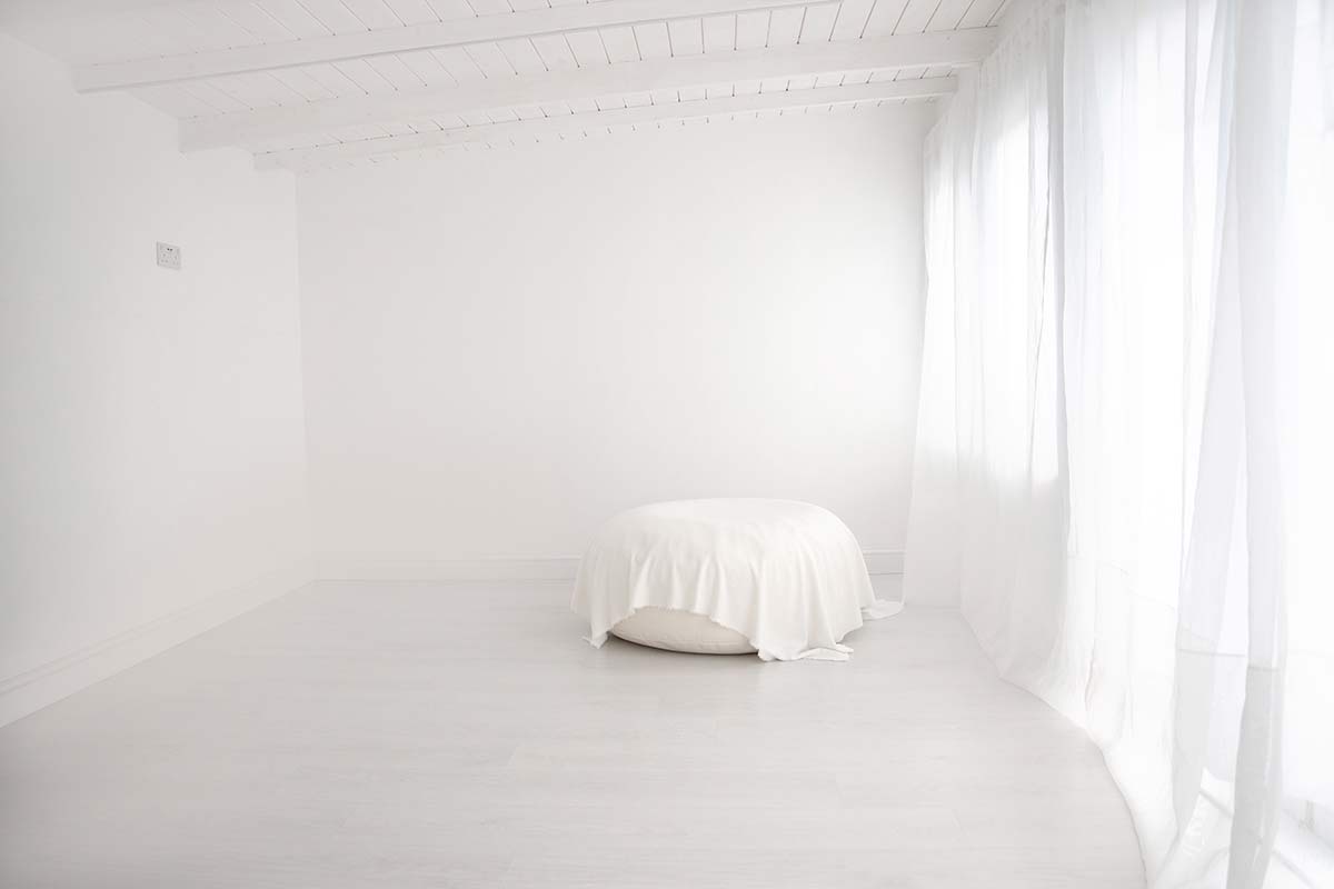 Bright and airy newborn photography studio in Twickenham, featuring white walls and natural light for a calm, welcoming experience.